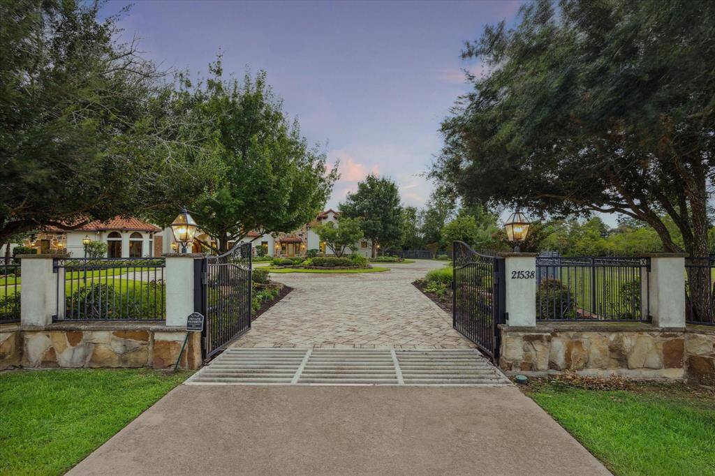 Access to the home is protected by two motorized double gates leading to the expansive circular motor court with over 12,000 square feet lain in pavers. 6’ and 8’ wrought iron fence surrounds the property, equipped with a Lutron HomeWorks Automation System which controls the gates, lighting, music, media, security, window treatments and door locks at the touch of a finger.