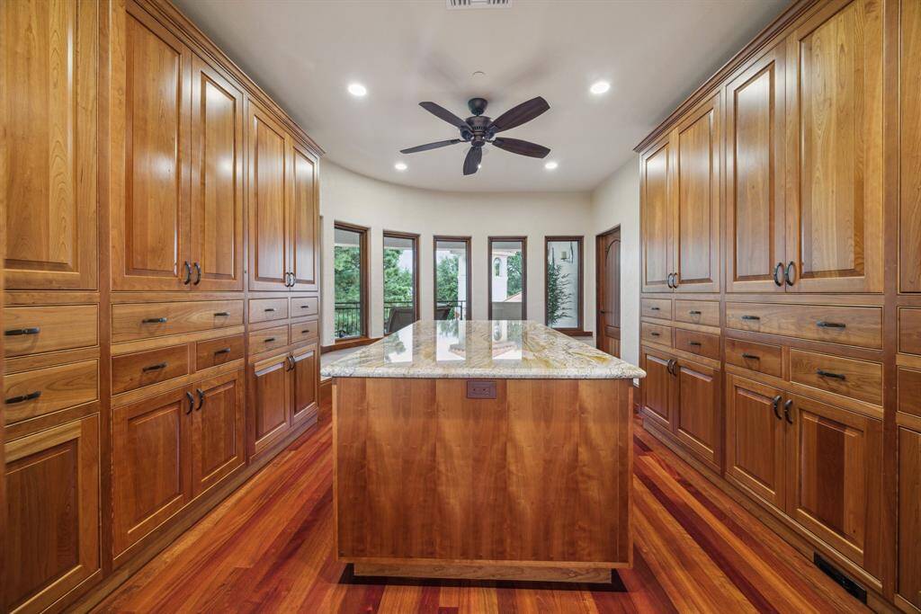 A nearby craft room boasts an enormous island with specialized storage for gift wrap and crafting accessories. This room could also function as an additional bedroom or office space and overlooks the rear balcony and waterpark.