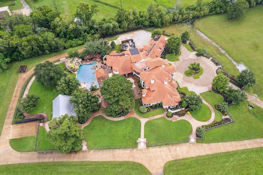 The home was constructed in 2012 on an upgraded 6’ slab and features geothermal heating and cooling systems, Crestron programmable thermostat, spray foam insulation, Lutron window treatments, Marantz intercom and speaker system, solar panels. The estate also features a coveted separate guest house comprised of 3 bedrooms and 2 baths on the property for nannies, house staff, in-laws or adult children.