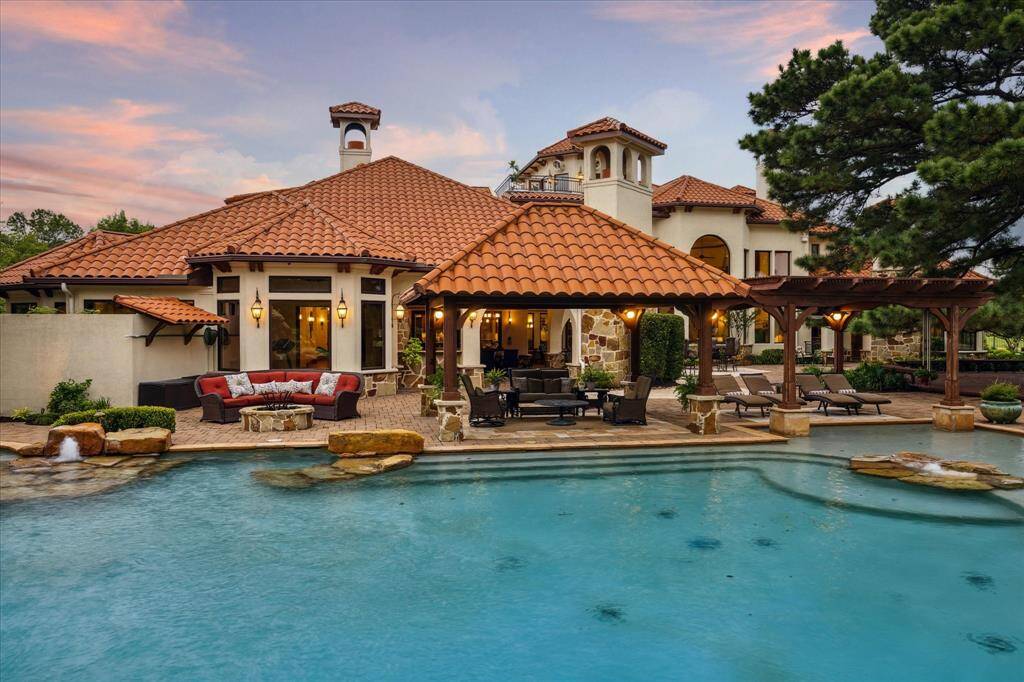 The rear elevation of this Mediterranean estate is as architecturally pleasing as the front. No detail has been overlooked.