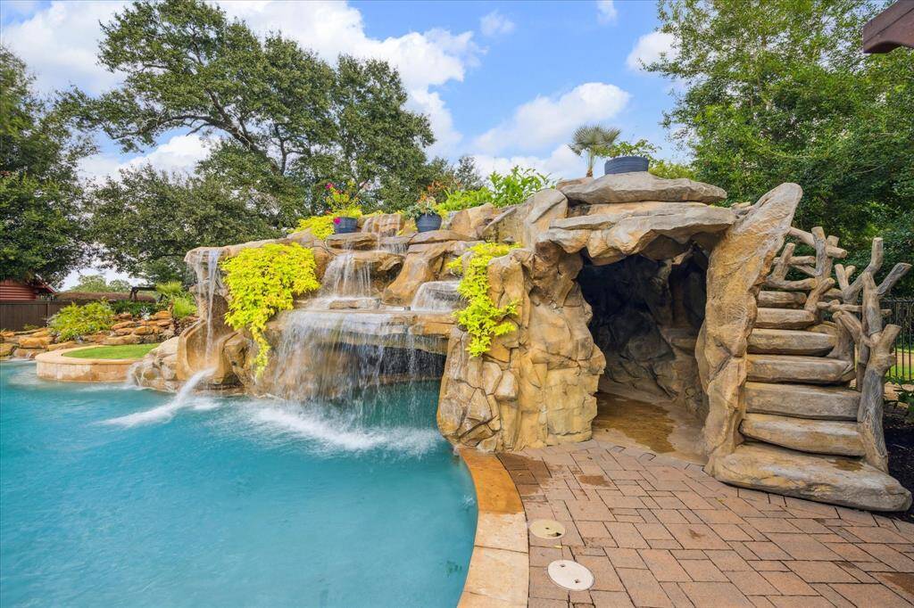The waterfall slide provides hours of fun for kids and adults alike. This rock waterfall and grotto adds a distinctive look to this pool and the tranquil and relaxing sound of moving water in a mountain stream.