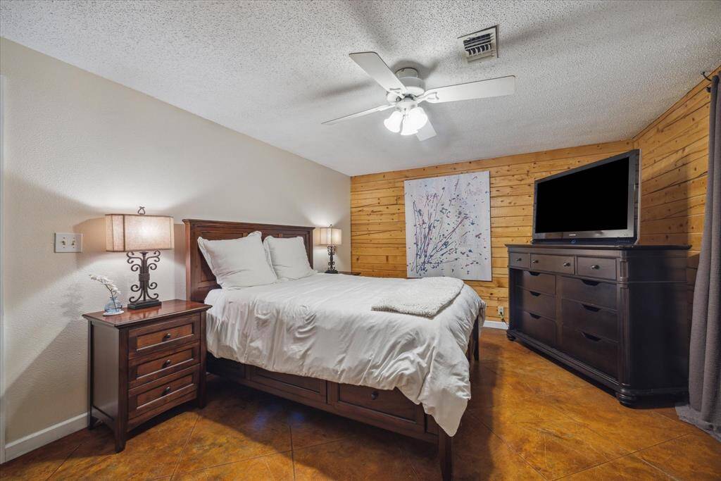 The primary bedroom suite is one of two first level bedrooms in this 3 bedroom guest house. The charming independent guest cottage provides privacy for guests and homeowners alike.
