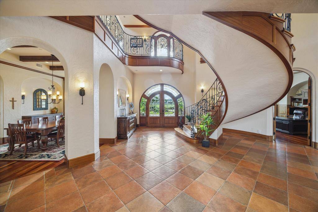 Mediterranean architectural elements like arched niches, arched doors and arched doorways appear harmoniously throughout the home. The interior is a relaxing sanctuary filled with rich texture, natural materials and earthy elements.