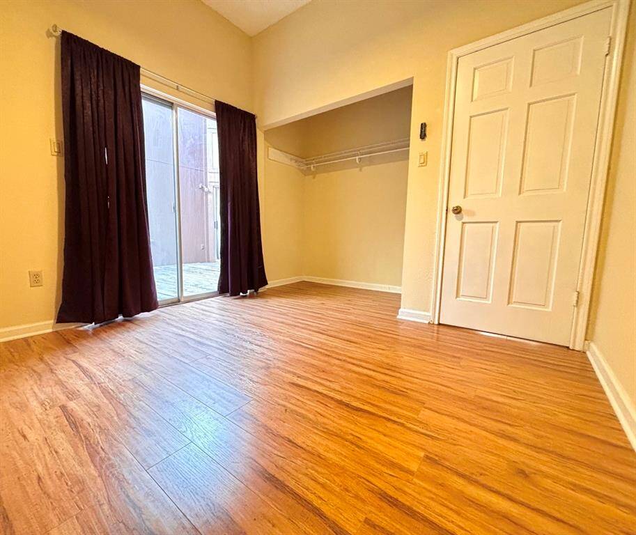 A cozy, welcoming guest bedroom with a comfortable setup that opens to the atrium.