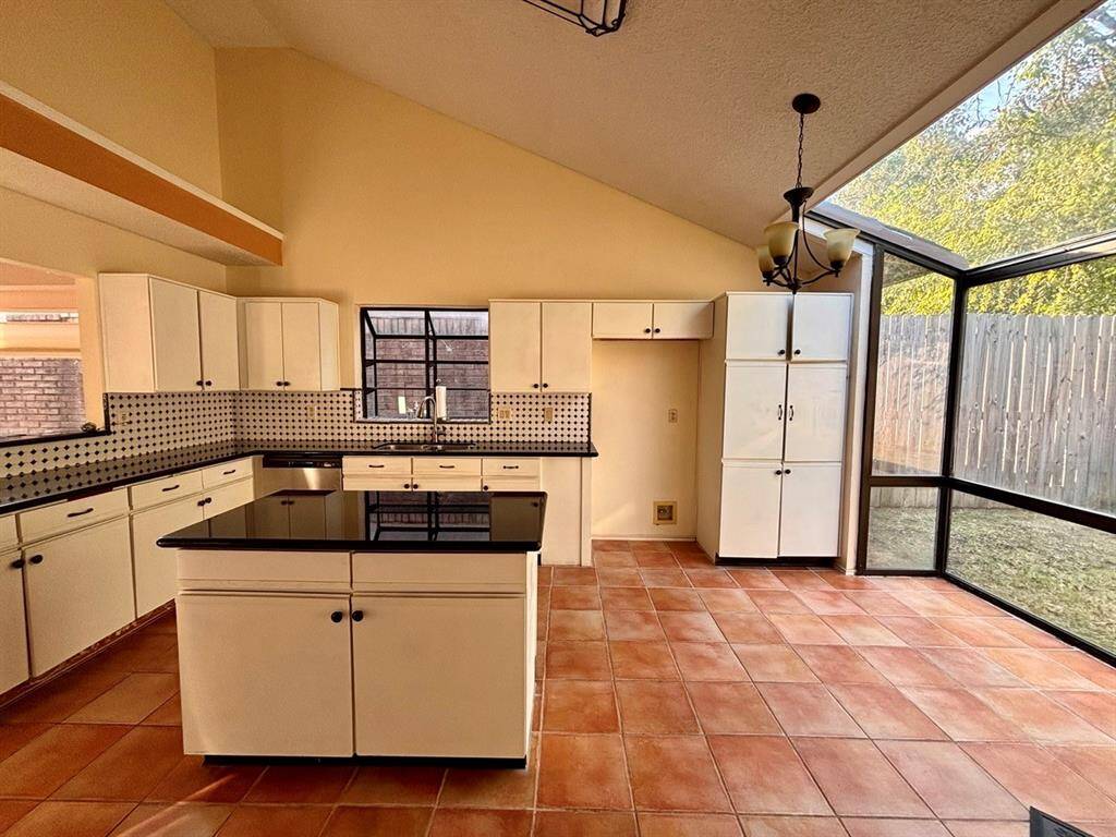 A spacious, bright kitchen with a sleek design, ample counter space, and a cozy bay window breakfast nook filled with natural light.