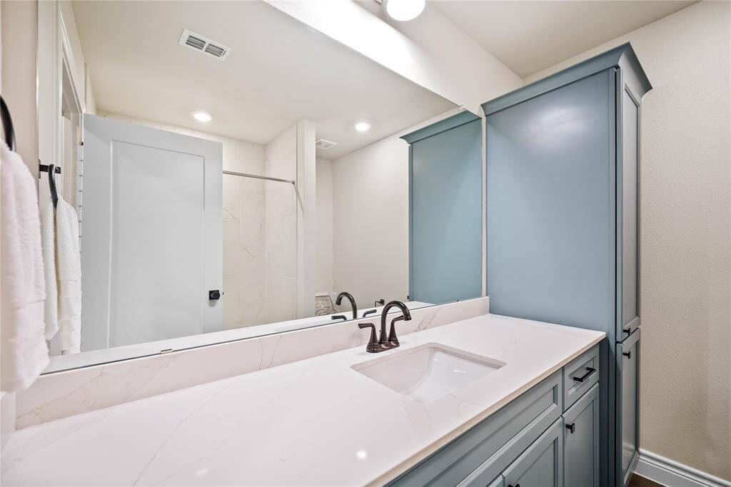 Hall Bathroom with Quartz Countertops and undermount sinks.  Included linen Cabinet