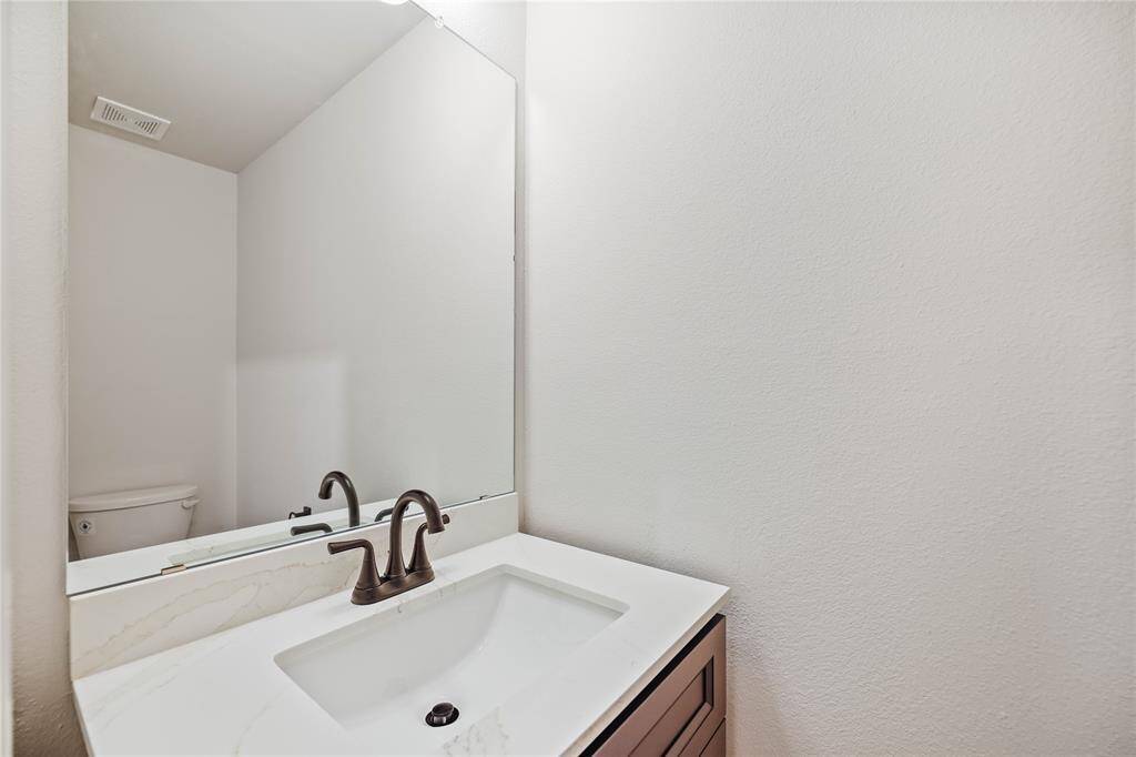 Included Powder bath with sink base cabinet, quartz countertops, and undermount sink.