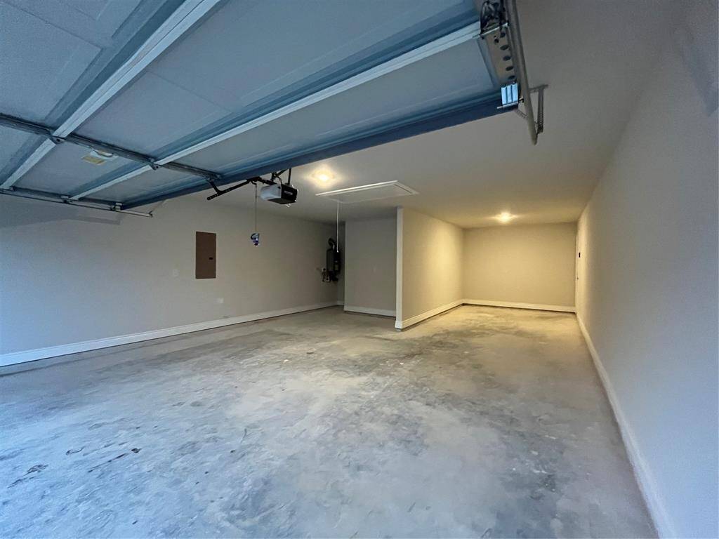 3 car tandem garage and view of the tankless water safely installed in the garage!