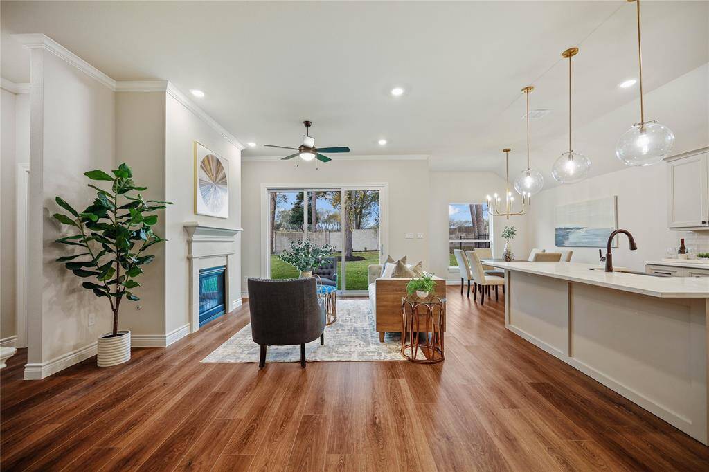 large Living space with included gas fireplace, upgraded mantle, and 9' multi-slide to oversized backyard.