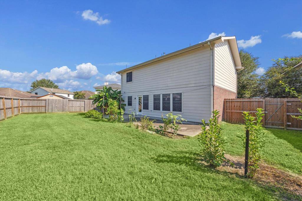 Large fenced backyard with an extended patio.