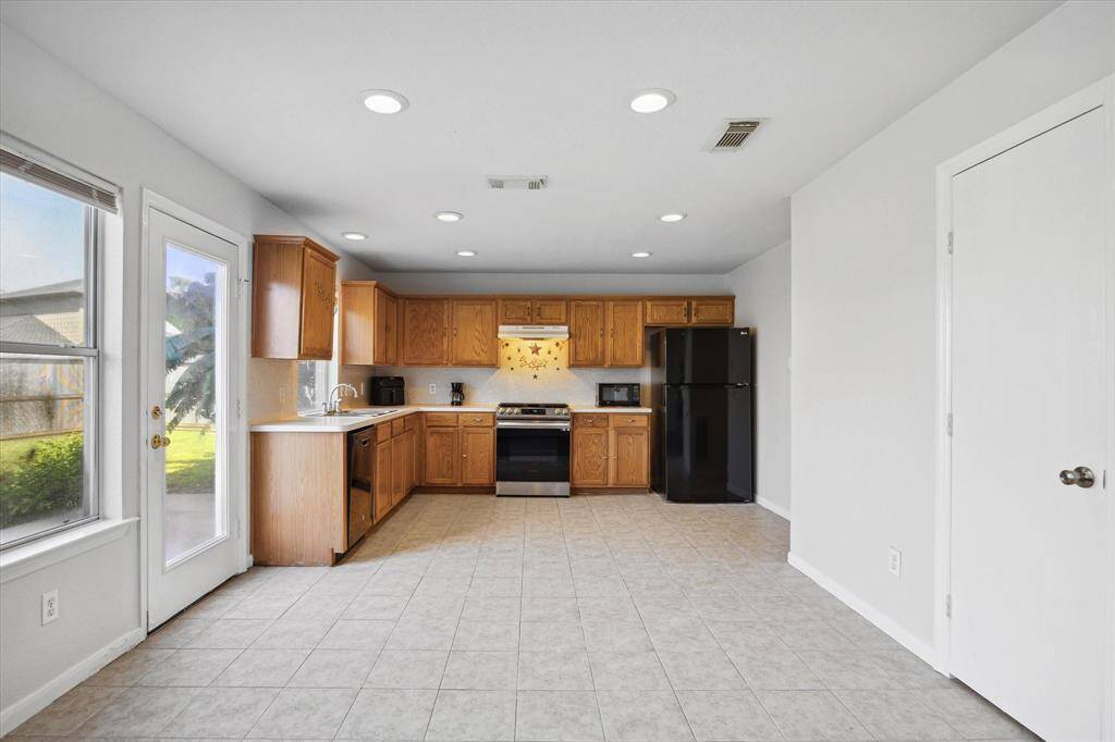 Open floor plan offers seamless movement between the kitchen and living area and all rooms have views to the backyard.