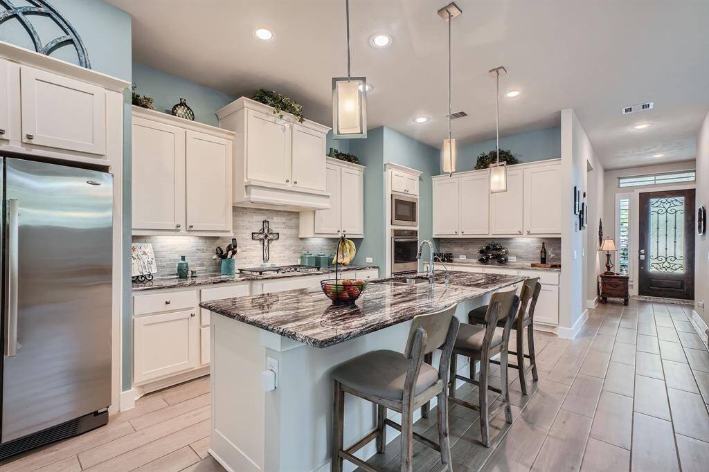 Gorgeous granite countertops are the focal point of this large, open kitchen