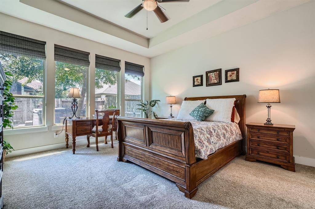 Primary bedroom overlooking the backyard and the spa