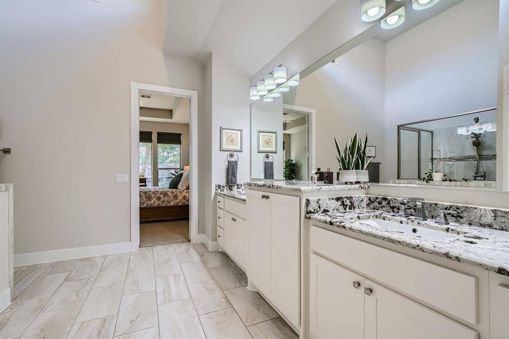 Primary spa-like bathroom with dual vanities and huge walk-in closet