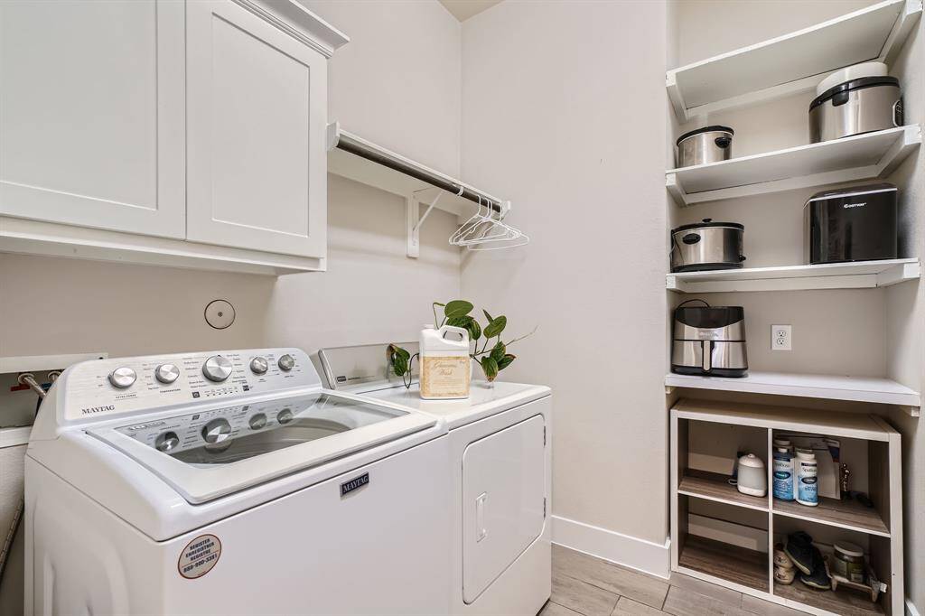 Oversized laundry room with storage shelves