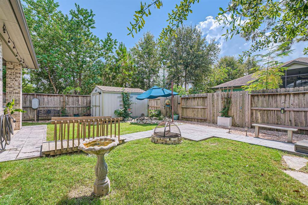 Welcoming back yard space with hot tub, fire pit, Koi pond and storage shed