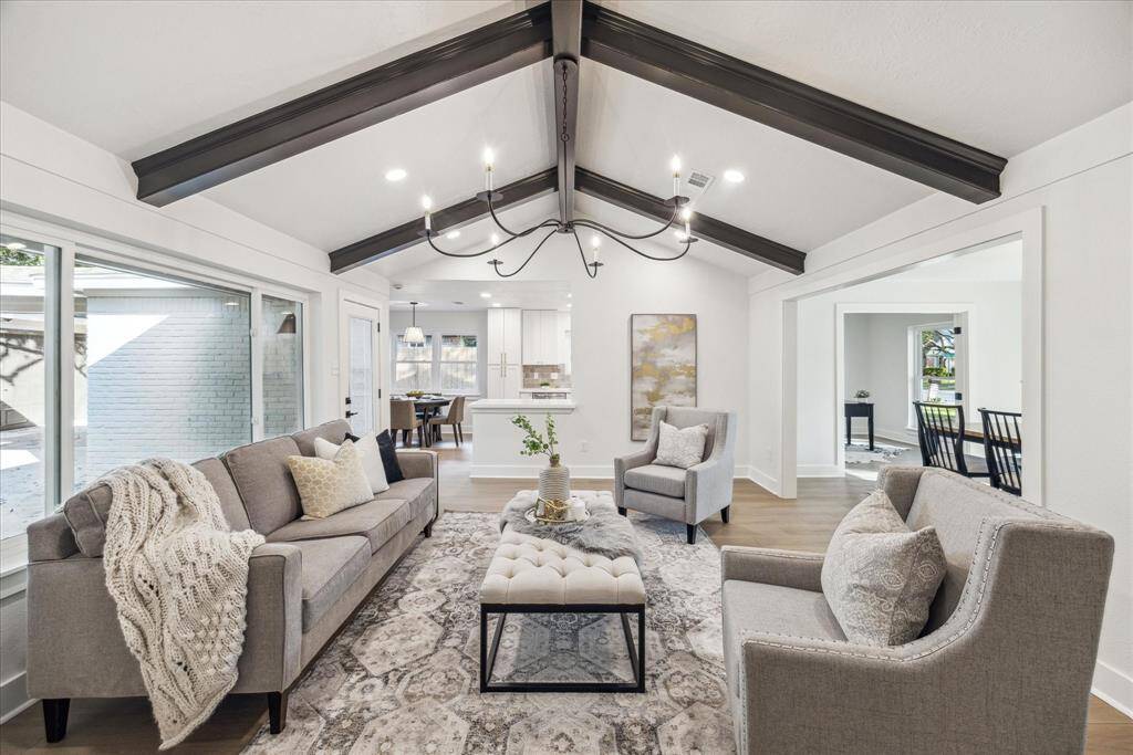 THE FAMILY ROOM FEATURES TRENDY CHANDELIER AND OPENS UP TO THE KITCHEN BREAKFAST AREA.