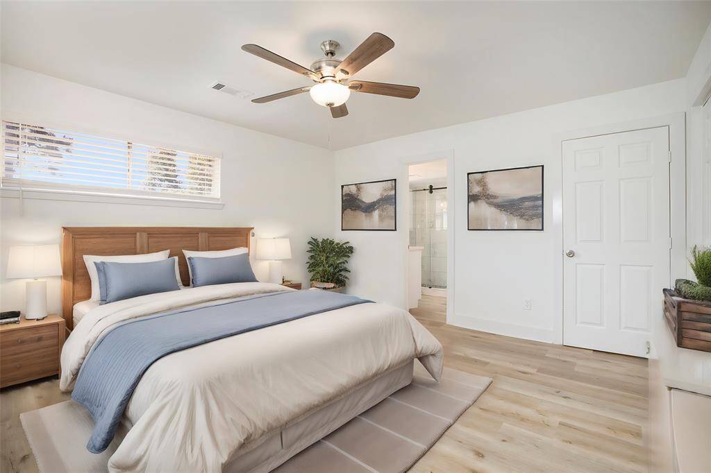 Virtually staged: Elegantly presented primary suite with a modern attached bathroom.