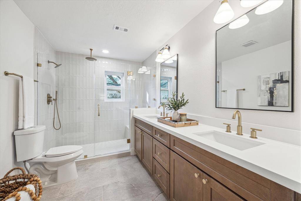 THE CUSTOM ENSUITE BATHROOM BOASTS KARAMEL SHAKER VANITY WITH UNDER-MOUNT DOUBLE SINKS. THE WALK-IN SHOWER IS HUGE WITH HIGH PRESSURE RAIN SHOWER HEAD.