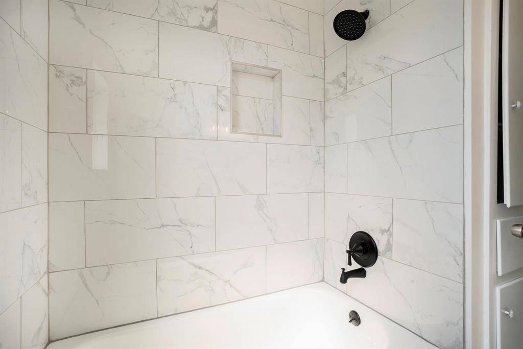 Versatile upstairs bath with sleek tub-shower combo, perfect for relaxation or quick refreshes.