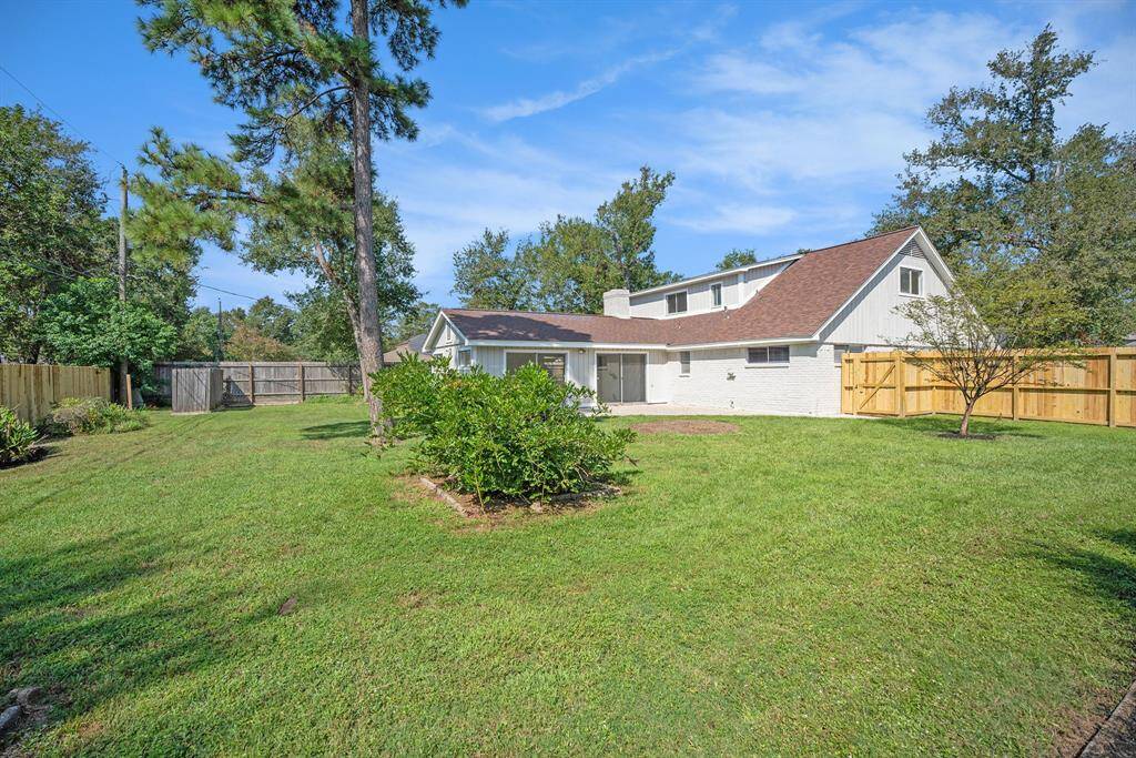 Charming two-story home with a spacious, well-maintained lawn and mature trees. The property features a privacy fence and an attached garage, set in a peaceful neighborhood.