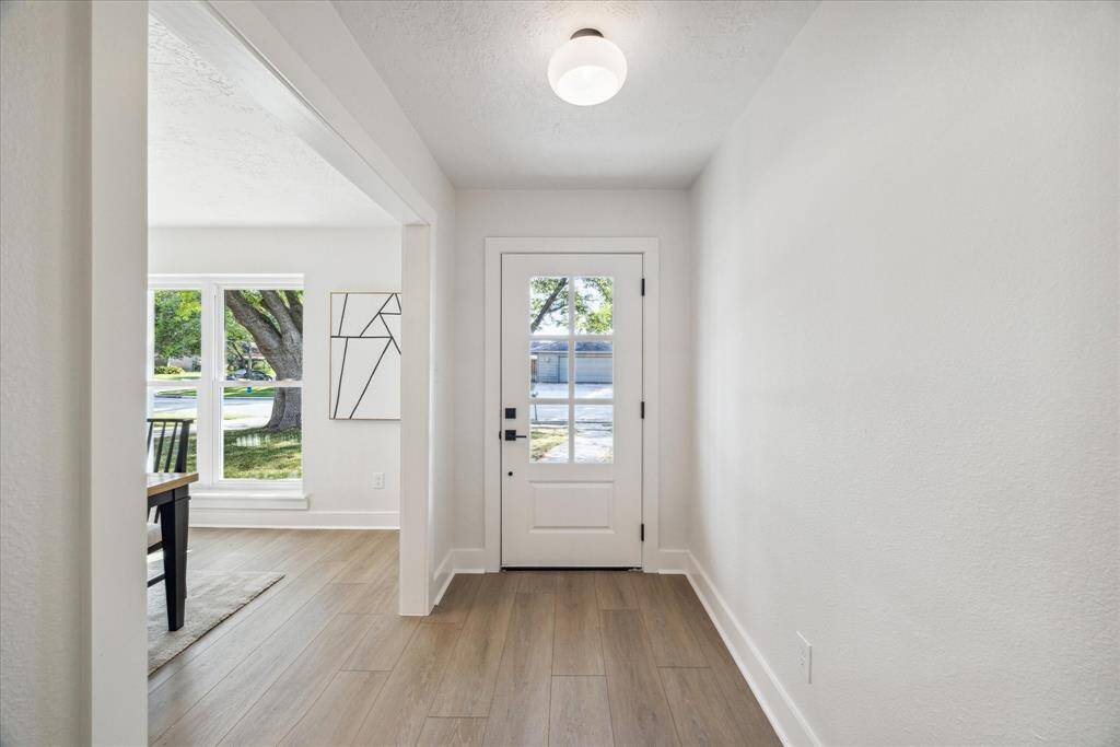 VIEWS OF THE ENTRANCE HALL WITH OPENING TO THE FORMAL DINING ROOM.