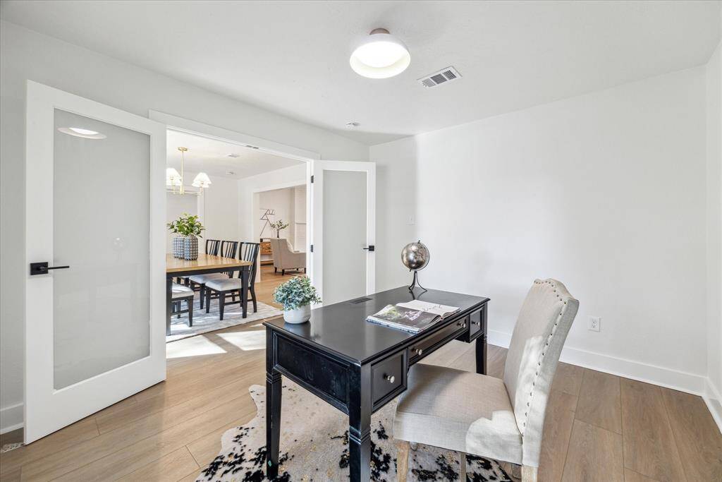 ANOTHER VIEW OF THE SERENE STUDY WITH PLENTY OF SPACE FOR AN EXECUTIVE DESK.