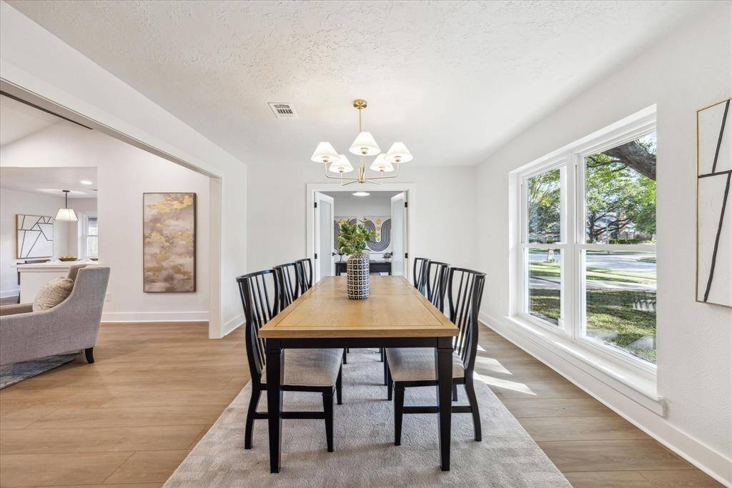 THE FORMAL DINING ROOM IS BRIGHT AND AIRY WITH LARGE PICTURE WINDOWS ALLOWING IN PLENTY OF NATURAL LIGHT.