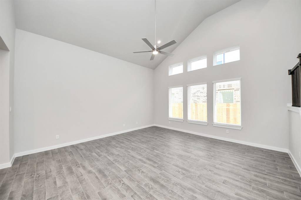 Family room flooded with natural light through the expansive windows.