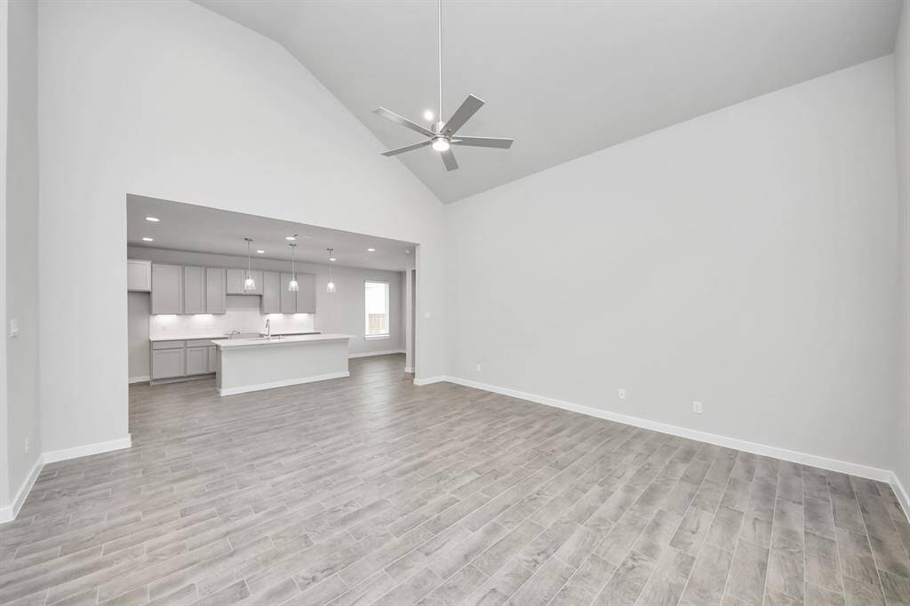 This kitchen is by far any chef’s dream! This spacious kitchen features high ceilings, light stained wood cabinets, granite countertop, SS appliances, modern tile backsplash, recessed lighting, extended counter space, granite kitchen island with double sink, and space for breakfast bar, and a walk-in pantry all overlooking your huge family room.