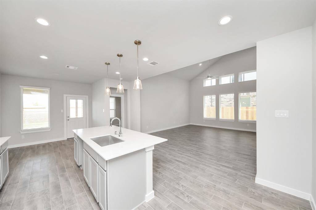 Discover another perspective of this stunning kitchen, generously appointed with an abundance of counter space