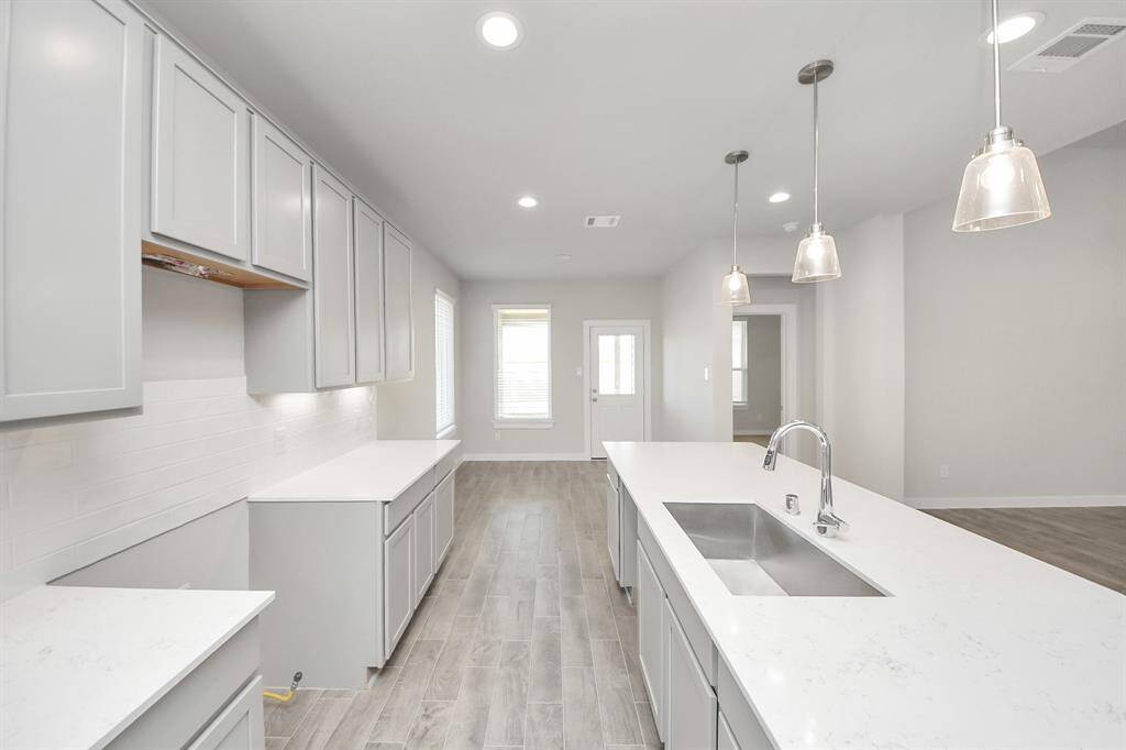 Enjoy breakfast with ease in the connected and cozy breakfast area, seamlessly integrated with the kitchen for utmost convenience. Step through the back door for a breath of fresh air onto the covered patio, extending your living space to the outdoors.