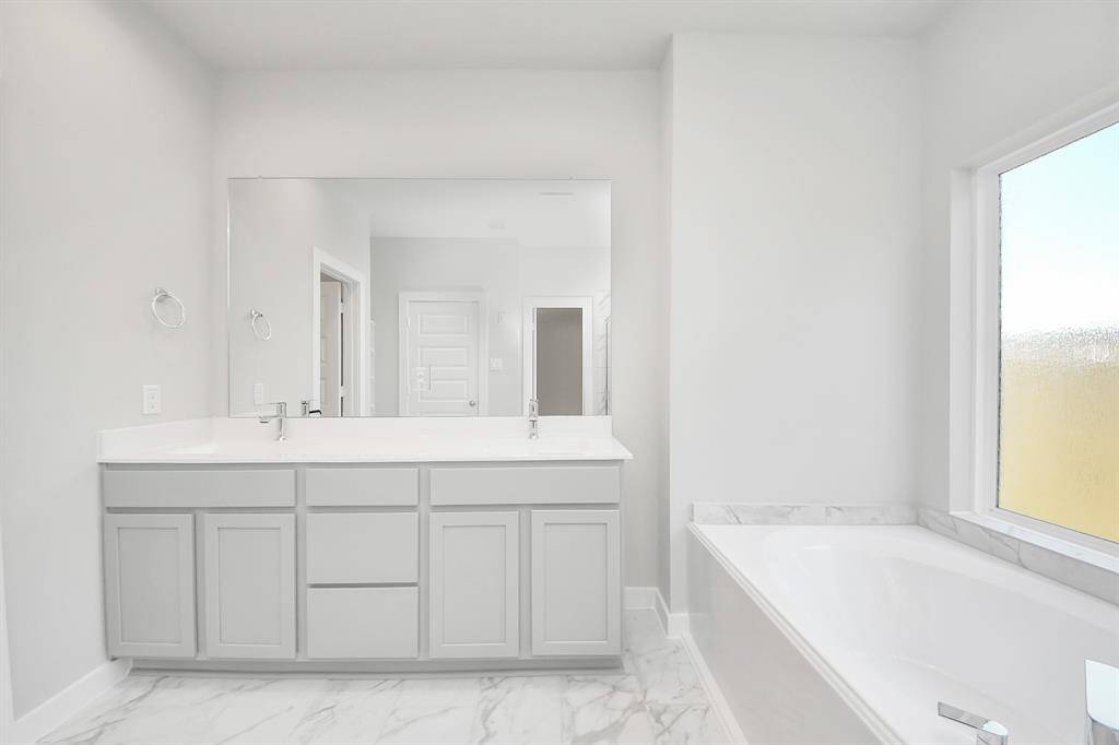 Walk-in closet that epitomizes luxury and practicality. This generously sized space features built-in shelving, offering abundant room for impeccable organization. High ceilings and recessed lighting create a bright and welcoming ambiance.