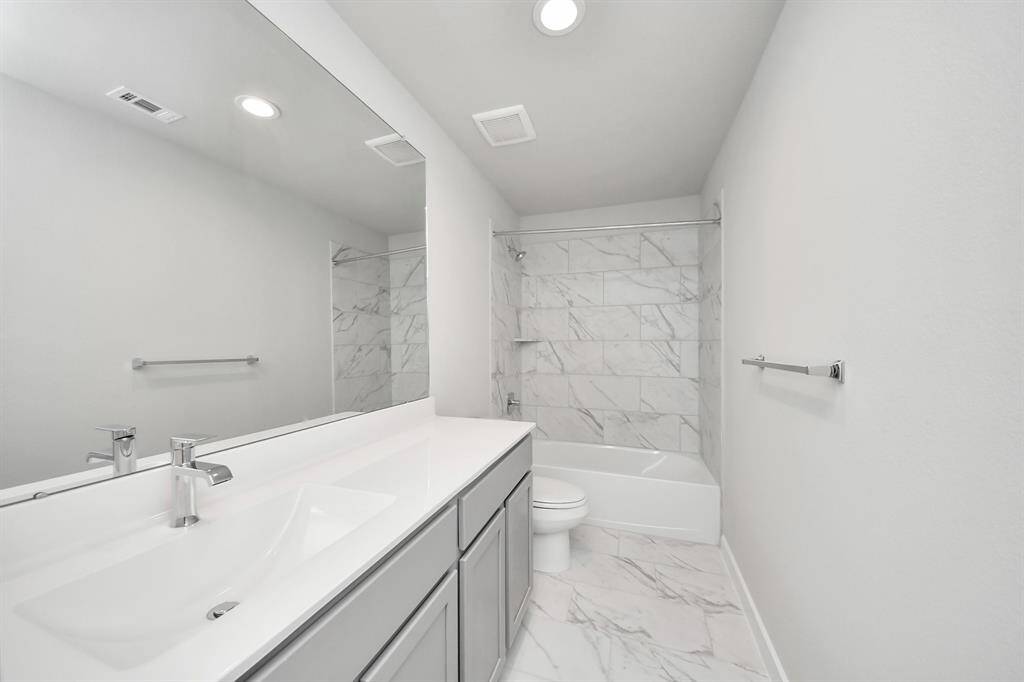 Generously sized secondary bedrooms featuring spacious closets, soft and inviting carpeting underfoot, large windows allowing plenty of natural light, and the added touch of privacy blinds for your personal retreat.
