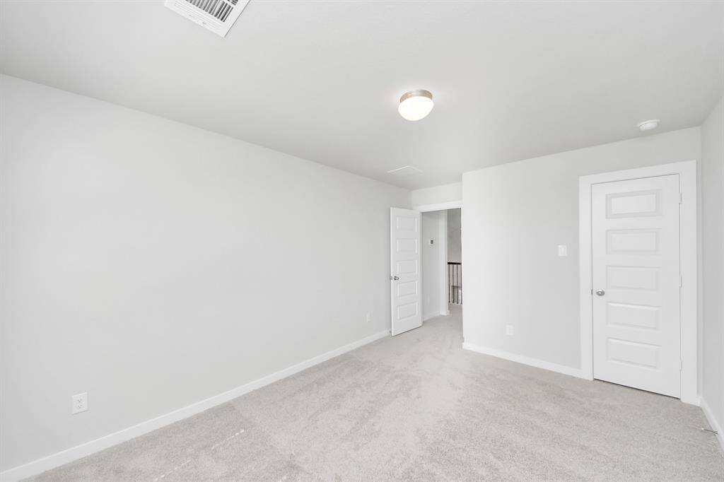 Generously sized secondary bedrooms featuring spacious closets, soft and inviting carpeting underfoot, large windows allowing plenty of natural light, and the added touch of privacy blinds for your personal retreat.