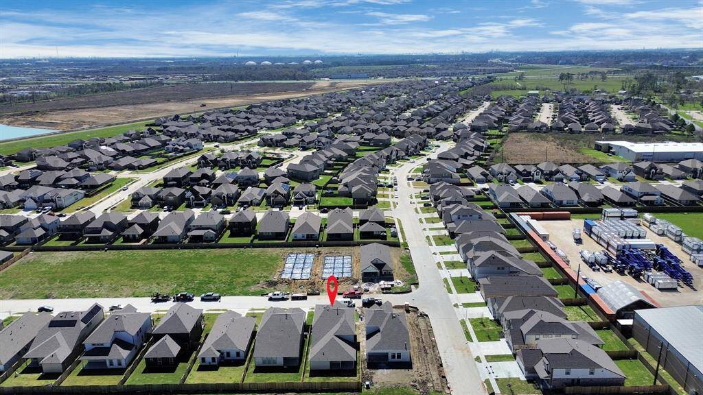 An aerial view of a spacious subdivision lot, highlighting a well-maintained yard and a fully fenced perimeter, offering both privacy and expansive outdoor space.