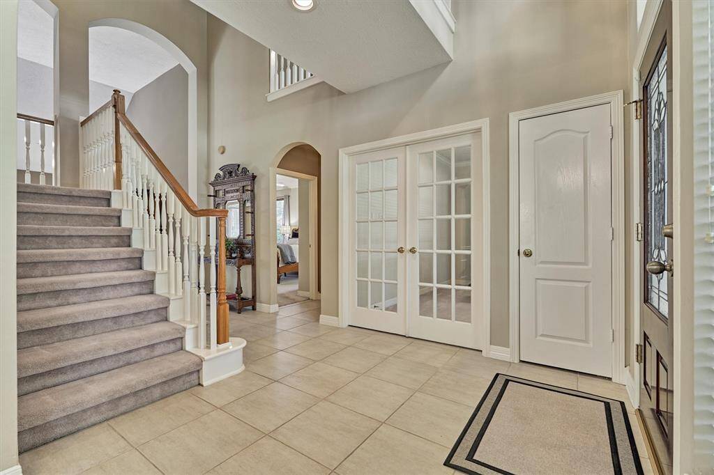 Look to the right to see French doors opening to an elegant office