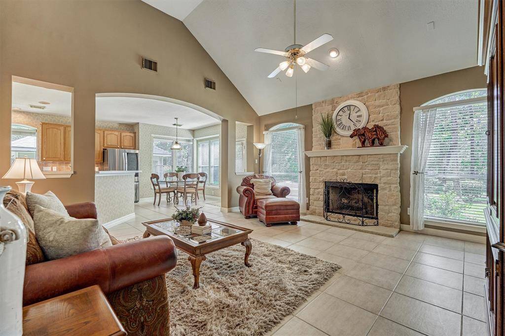 Main family room has stone, gas-log fireplace and views out to the backyard