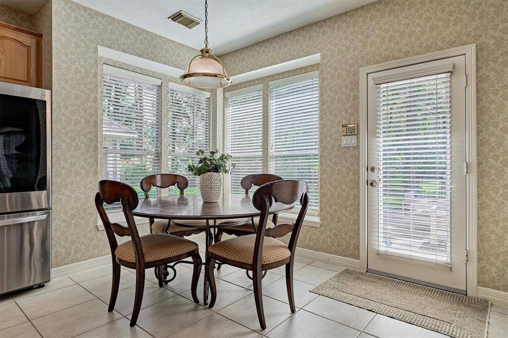 Backyard bay window views and back door to patio surround the Breakfast area