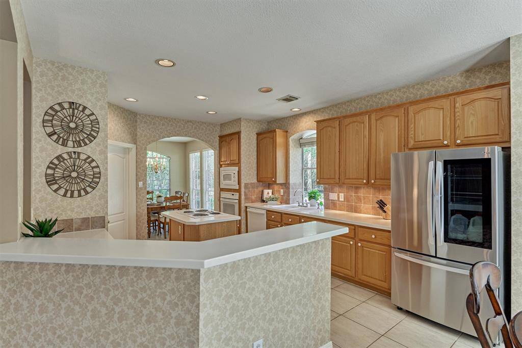 Island kitchen opens to living area and offers plenty of storage space