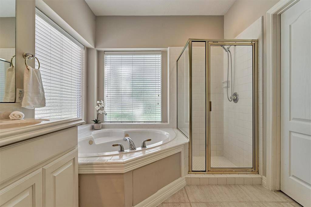 Primary bathroom with a garden tub, separate shower, linen closet, toilet room, and 2 closets