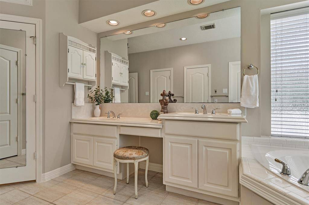 primary Bathroom has 2 sinks split by a vanity and plenty of counter space