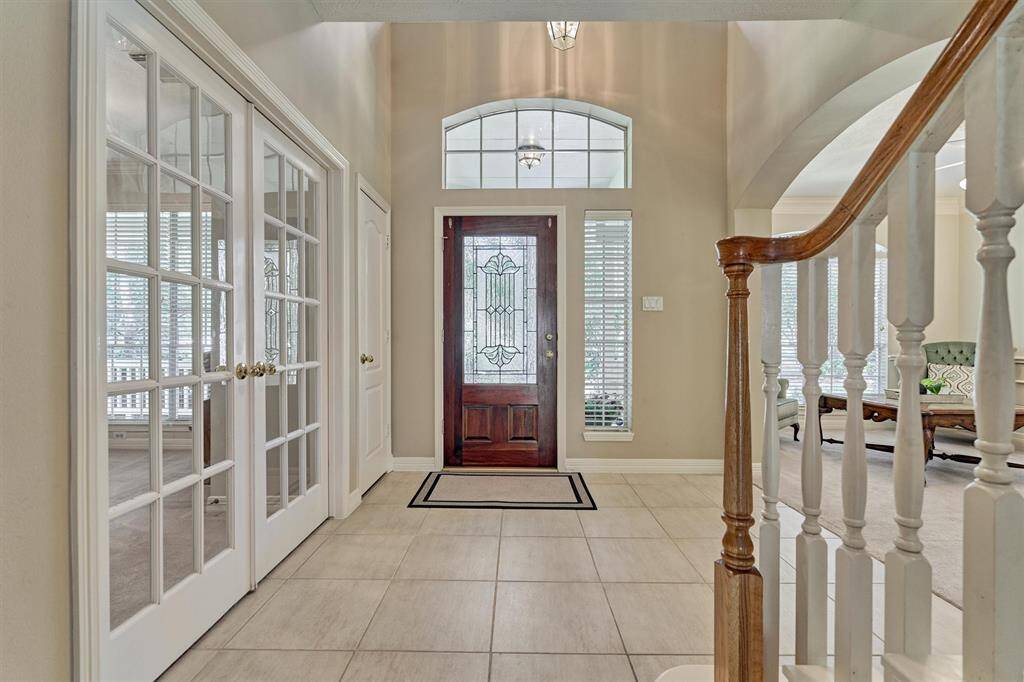 Foyer invites you in with high ceilings and a view up the staircase