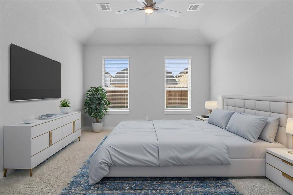 Come and unwind after a long day in this magnificent primary suite! This spacious room features plush carpet, neutral paint, high ceilings, ceiling fan, and large windows with privacy blinds.