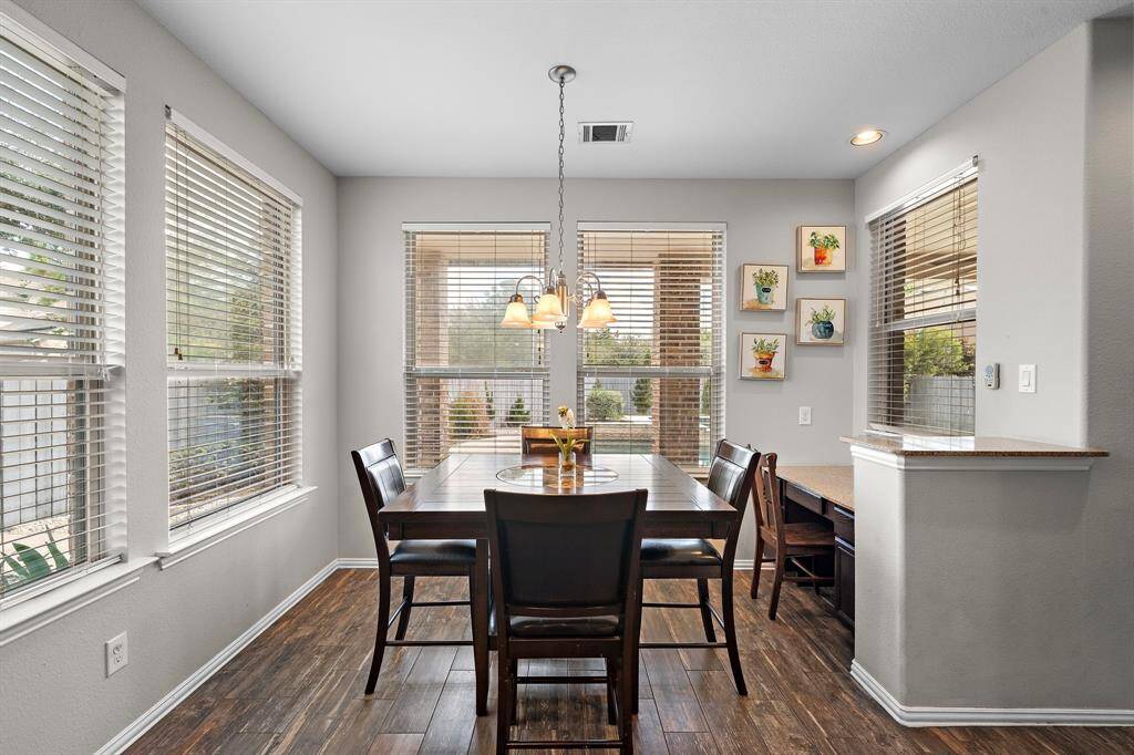 The breakfast area and additional desk is located off of the kitchen.