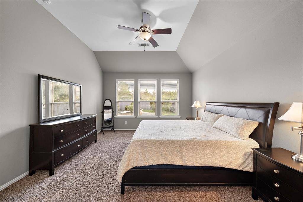 The primary suite also features a wall of windows allowing for natural light to come through.