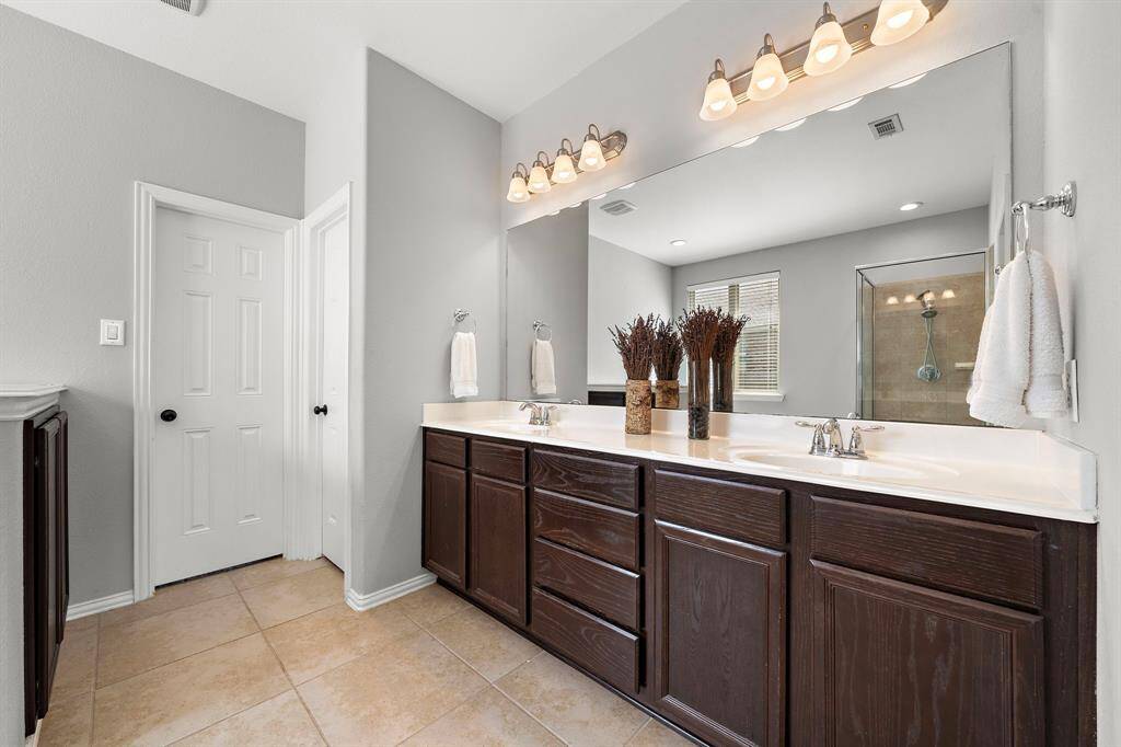 The primary bathroom features double sinks.