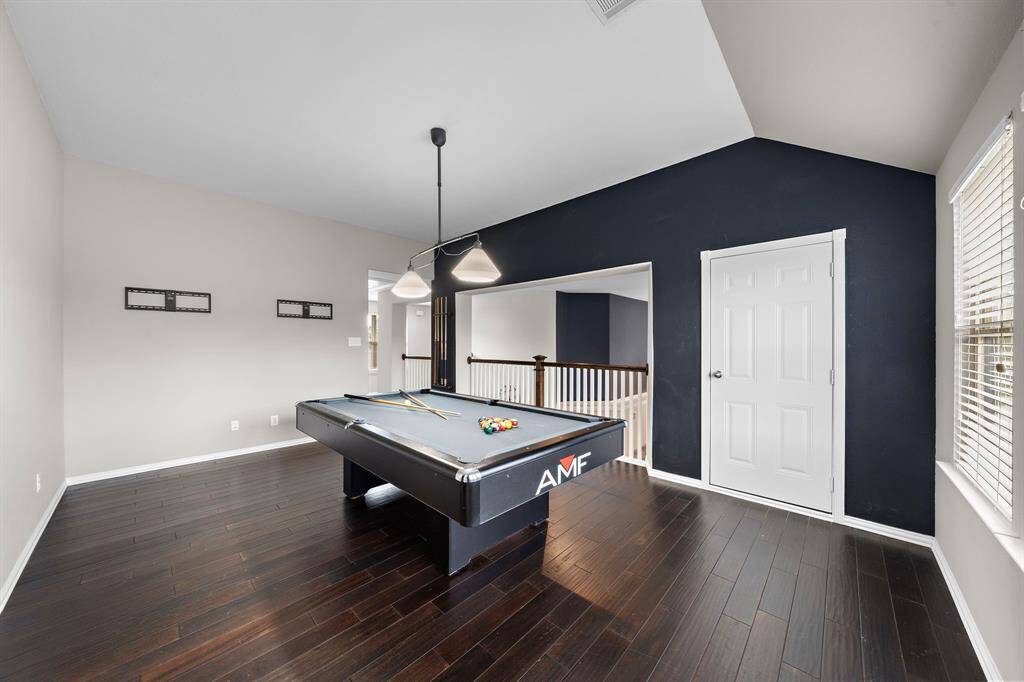 The game room features engineered hardwood floors and a walk-in attic space.