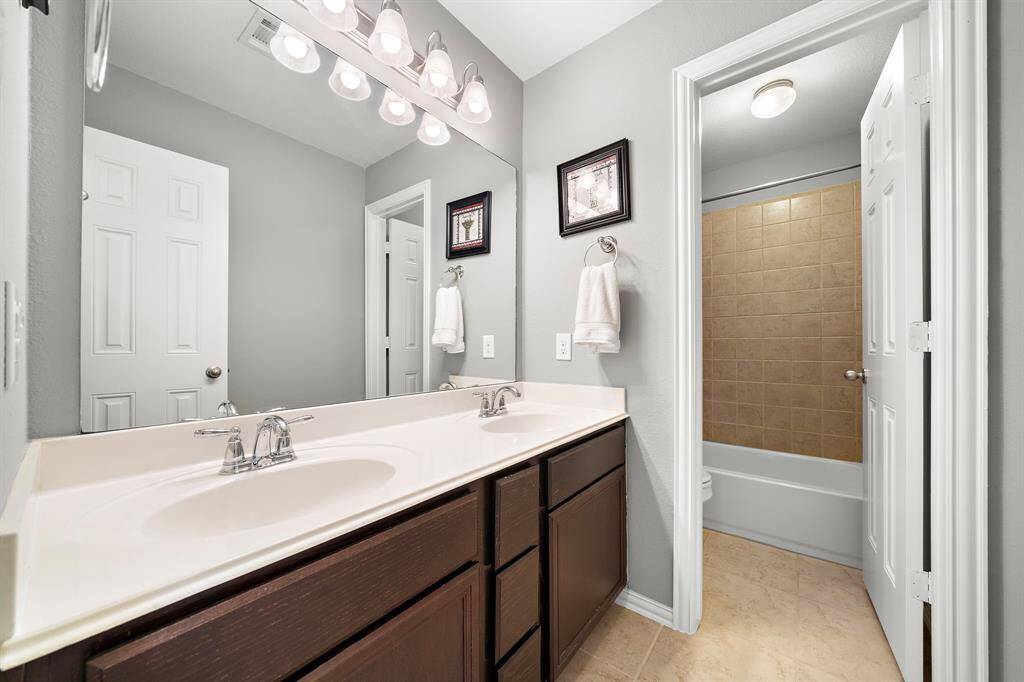 Full Bathroom #2 shared between bedrooms #2 and #3, features double sinks.