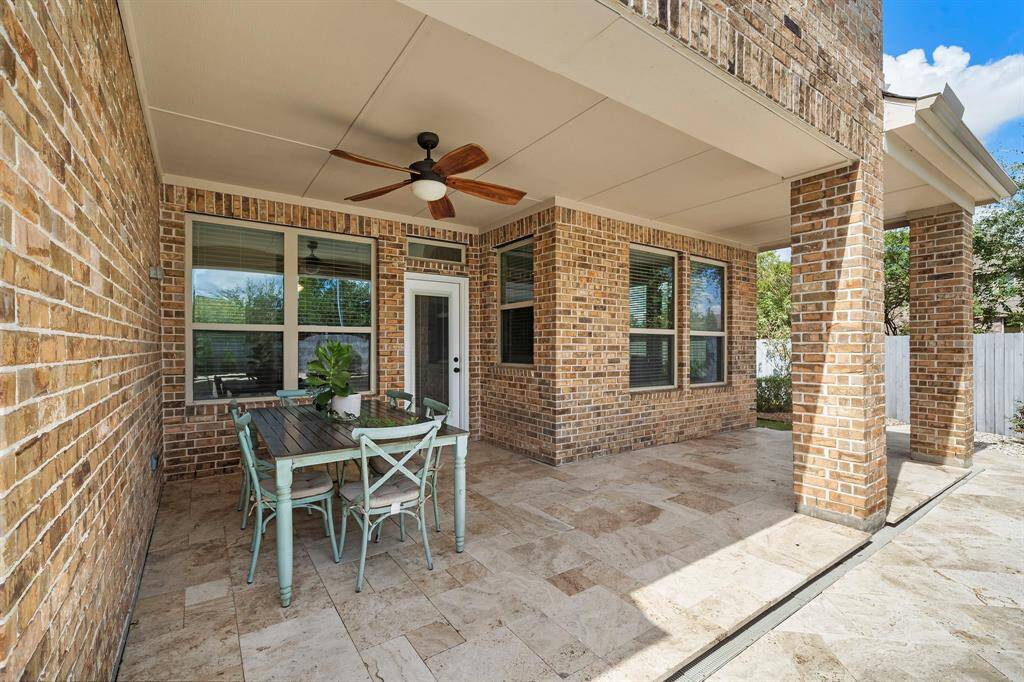 Beautiful outdoor covered pation featuring travertine decking and a gas stub for your outdoor kitchen.